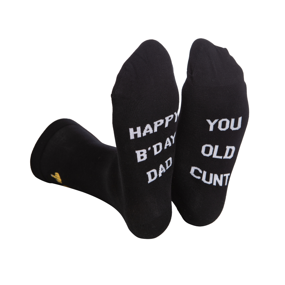 Black rude slogan socks with white happy b day dad and you old cunt text and gold logo on the heel for dad gift