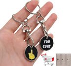 Black octagonal keychain trolley coin with yellow finger gesture white text you cunt silver metal clip ring attachment