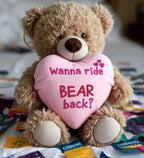 Cheeky Chappies Bear back plush tan teddy bear holding a pink heart pillow with wanna ride bear back embroidered in red