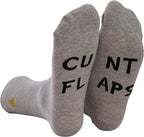 Gray crew socks with black rude slogan text cunt flaps and a small yellow thumbs-up logo near the ankle