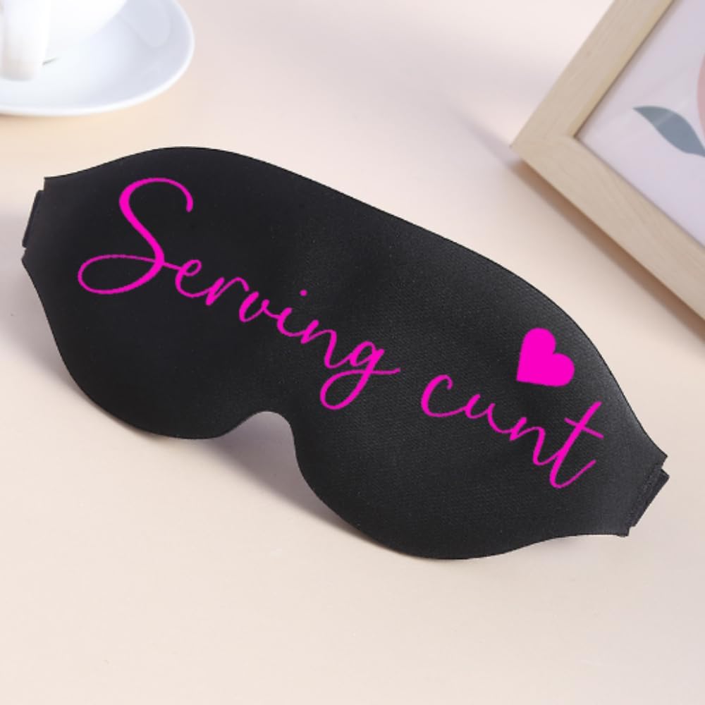Black sleep mask with pink cursive text reading serving cunt and a small pink heart for funny bedtime use